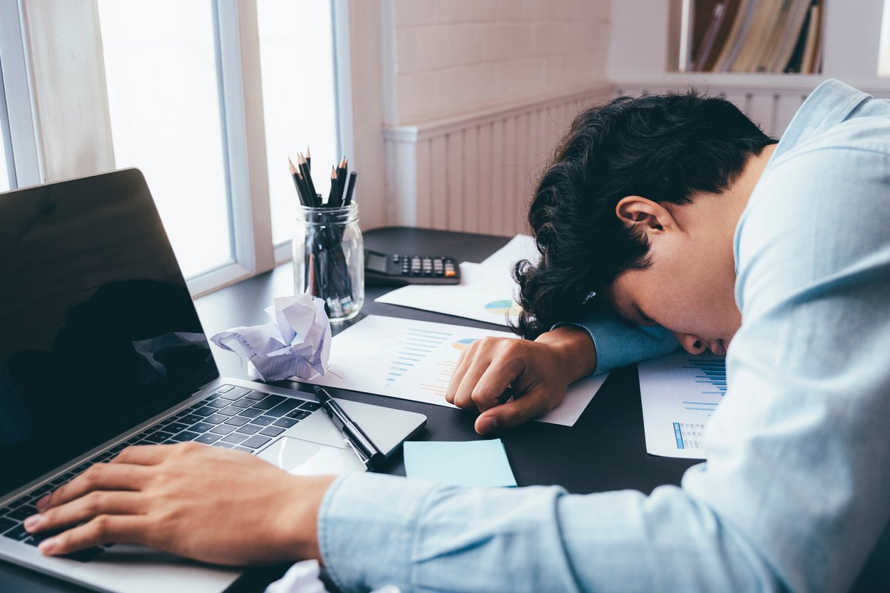 Tired Businessman Sleeping on His Desk